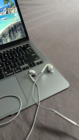Azuro chrome earbuds on a laptop keyboard