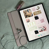 Azuro chrome earbuds beside a tablet in a pink case